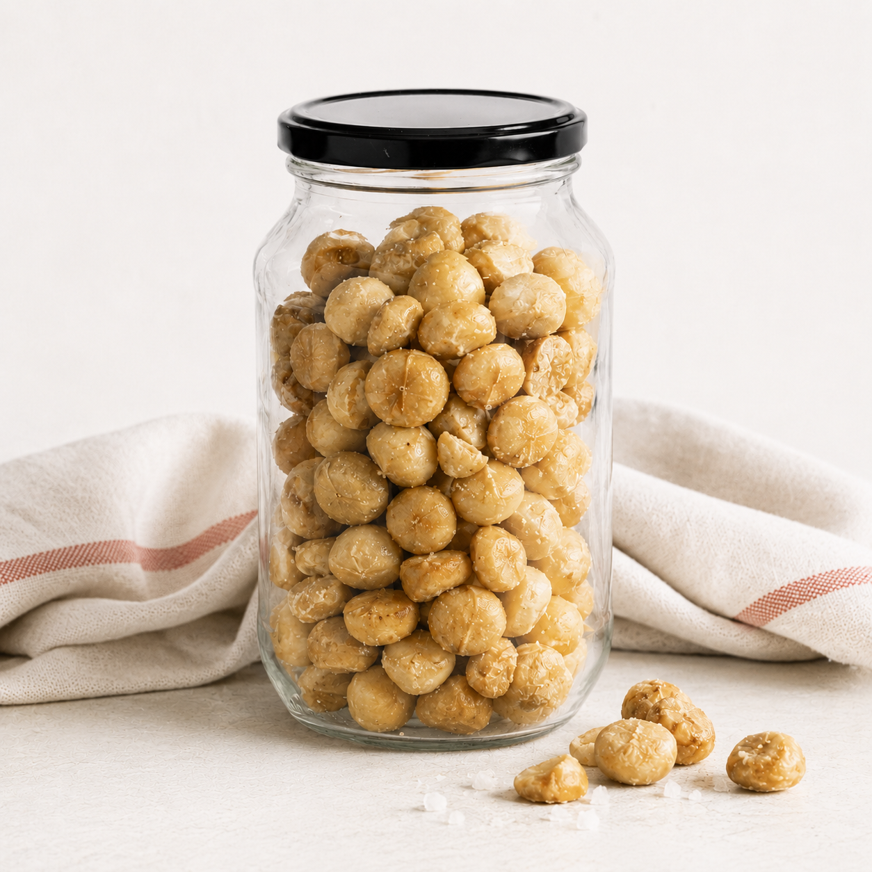 Roasted and salted macadamias in a glass jar